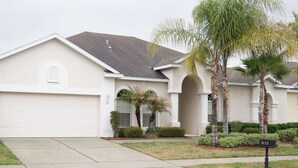 A single-story house with a garage, a front porch, and a mailbox. - 4 Bedroom Budget Home and Private Pool (Davenport)