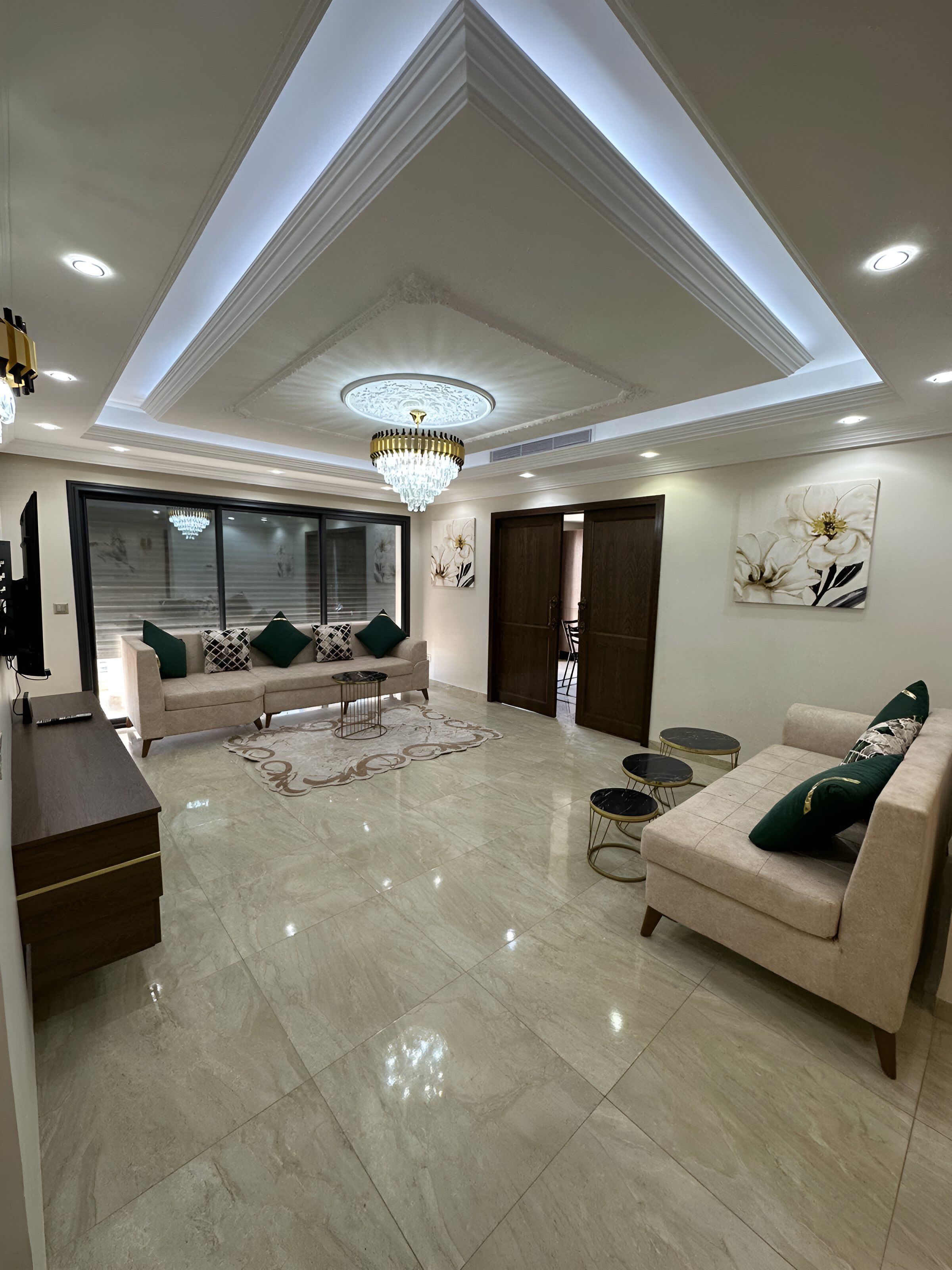 A modern living room with a sofa, coffee table, and decorative rug.