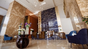 A modern lobby with marble walls, a reception desk, and seating areas. - Cantonal Hotel Riyadh (Riyadh)