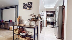 A modern kitchen with stainless steel appliances, a wooden cabinet, and a sign that reads "Parry Family".