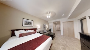 Relax in this inviting space with a large bed, desk, and sofa, perfect for unwinding.