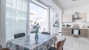 A modern kitchen with white cabinets, a microwave, and a stove. - ★ Penthouse w/ SEA VIEW in St. pauls bay ★ (San Pawl il-Baħar, Malta)