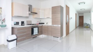 A modern kitchen with light wood cabinets, a stainless steel range hood, a microwave, and a coffee maker. - ★ Penthouse w/ SEA VIEW in St. pauls bay ★ (San Pawl il-Baħar, Malta)