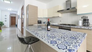 A modern kitchen with a central island, stainless steel appliances, and a tiled backsplash. - ☆☆Amazing Apartment w/side sea view☆☆ 1 (St. Pauls Bay, Malta)
