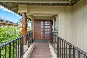 A wooden staircase leading to a door with frosted glass panels.