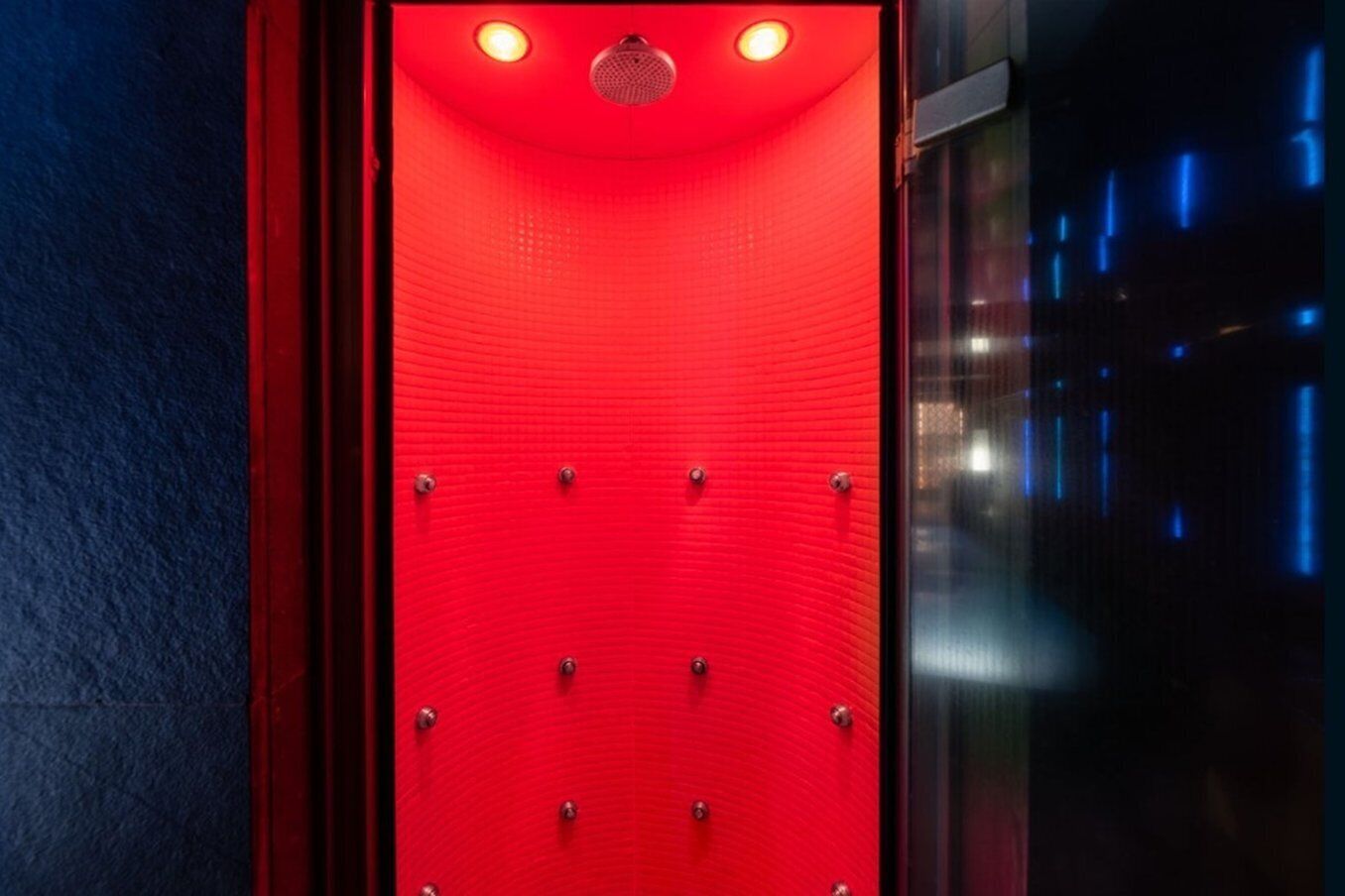 A red elevator with a textured surface and metallic rivets.