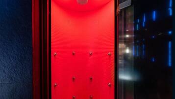 A red elevator with a textured surface and metallic rivets.