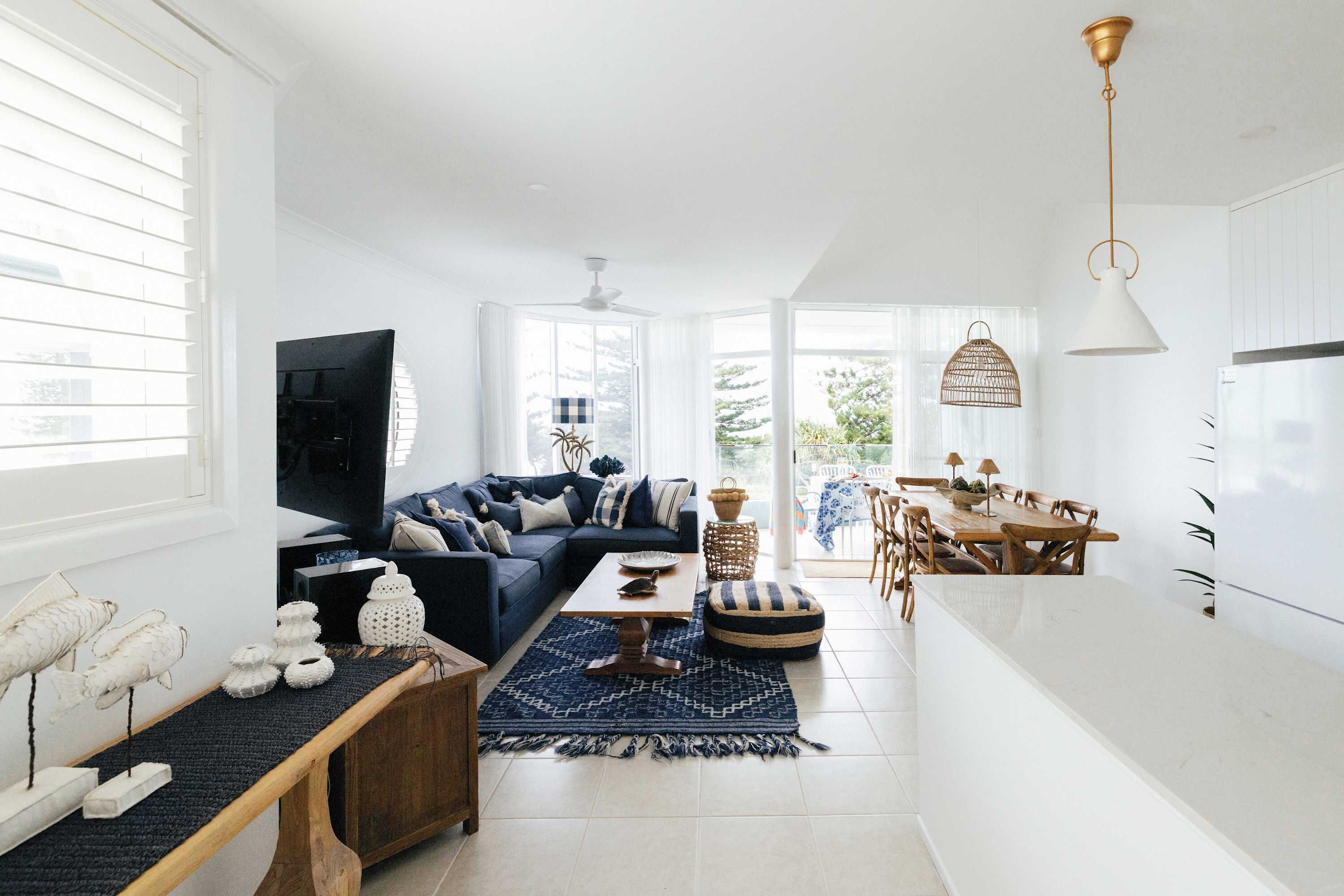 A modern living room with a sofa, coffee table, and decorative items.