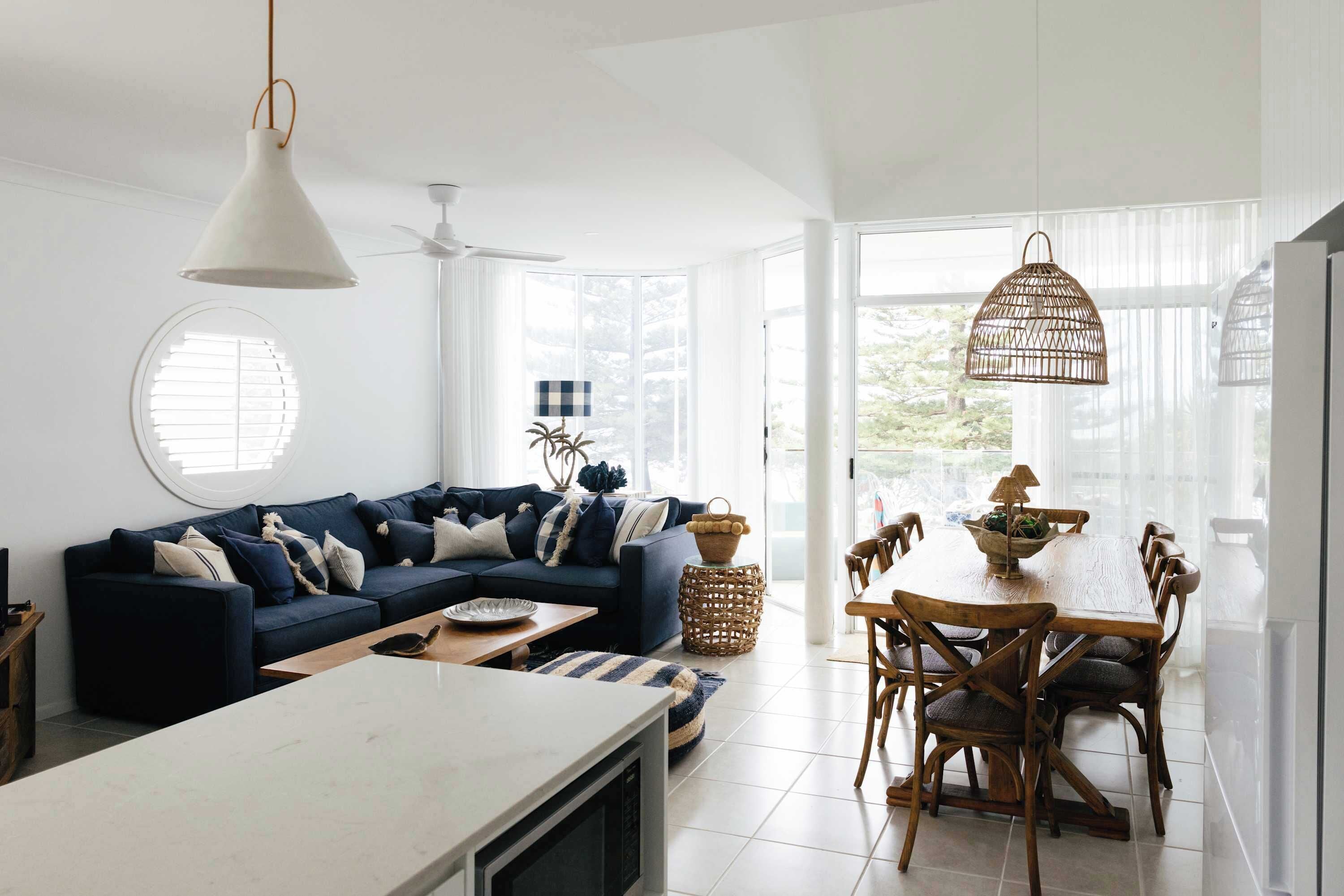 A modern living space with a sofa, dining table, and chairs.
