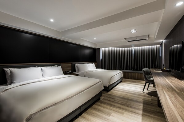 A modern hotel room with two beds, a desk, and a large window with curtains. - Autumn Willow Hotel (Taichung)