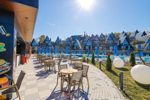 A resort with outdoor seating, a swimming pool, and chalet-style buildings. - World DREAMS Forest (Sapanca)