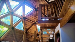 A wooden interior with a high ceiling and skylights. - Seacret Villa (Cóbano)