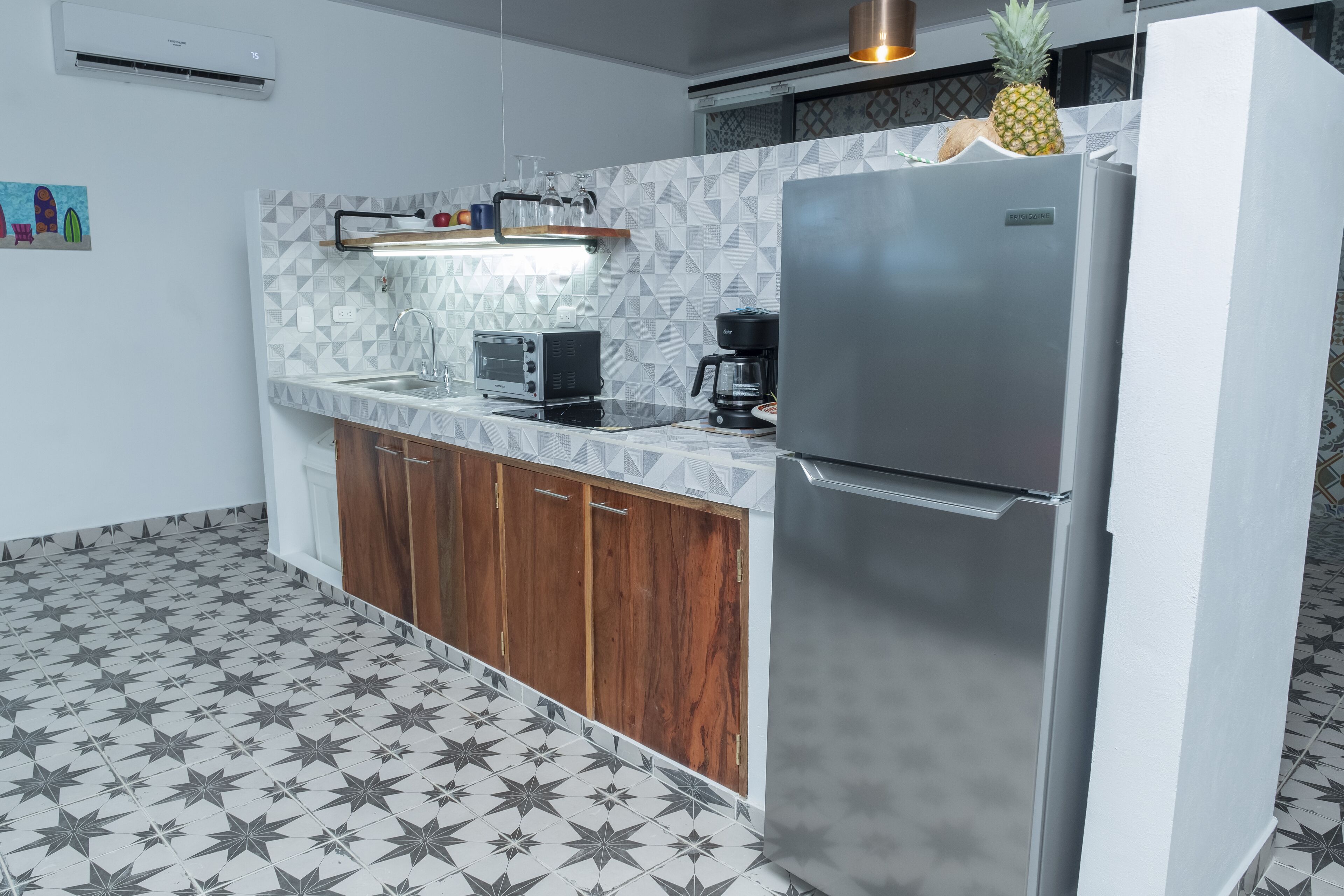 A kitchen with a stainless steel refrigerator, a microwave, and a coffee maker on the counter.