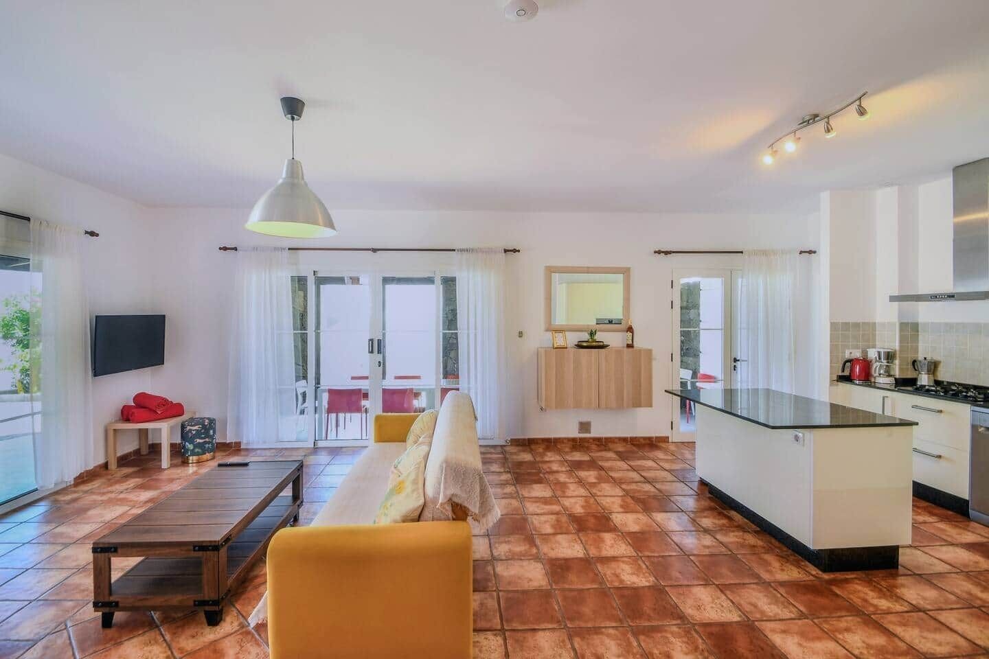 A modern apartment with a living room, kitchen, and dining area.