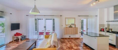 A modern apartment with a living room, kitchen, and dining area.