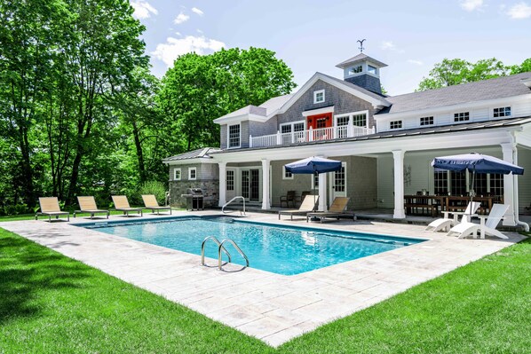 A two-story house with a swimming pool, outdoor seating, and a covered patio. - 6 Bedroom 6.5 Baths Heated In-ground Pool Located in Dock Square! (Kennebunkport)