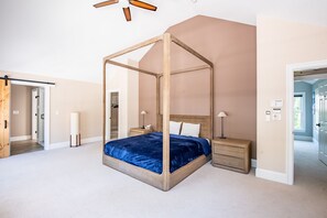 A bedroom with a four-poster bed, wooden nightstands, and a ceiling fan. - 6 Bedroom 6.5 Baths Heated In-ground Pool Located in Dock Square! (Kennebunkport)
