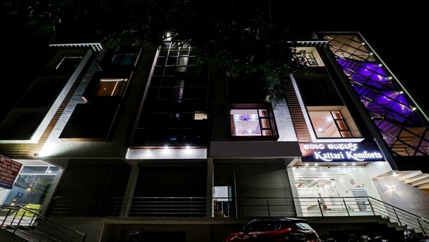 A multi-story building with a sign for 'Kattari Komforts'. - Itsy Hotels Kattari Komforts, Chikmagalur (Chikkamagaluru)