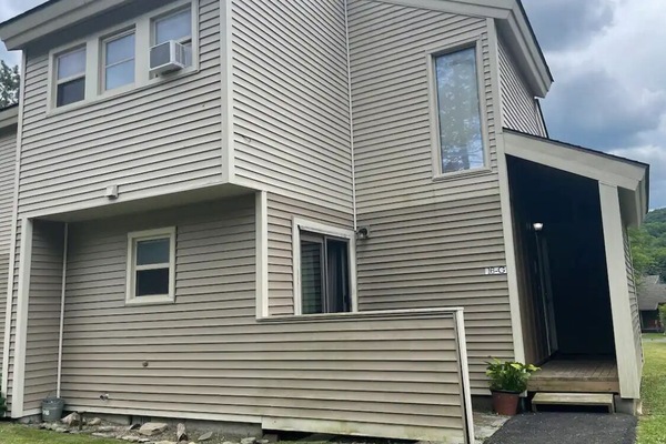 Condo entrance, green space and plenty of parking