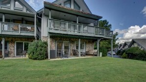 A two-story house with a balcony, stone facade, and a well-maintained lawn. - Golden Bear- lovely one bedroom with fireplace (Sky Valley)