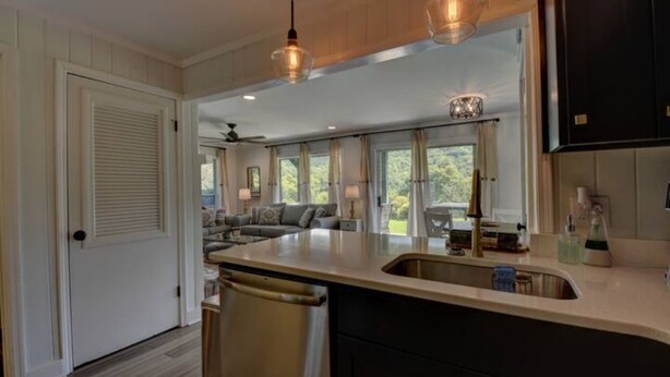 A kitchen with a large island, pendant lighting, and a view to the living area. - Golden Bear- lovely one bedroom with fireplace (Sky Valley)