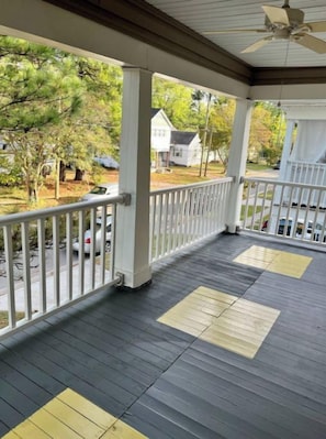 A covered porch with a view of a residential street. - Norfolk 3BR Cozy Stay. Central to All & Comfort. Families & Contractors! (Norfolk)