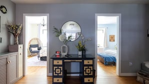 A bedroom with a bed, a desk with a mirror, and a dresser. - Classy 2BR/1,5BA Boutique at Flushing! (Queens)