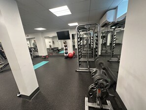 A gym with weightlifting equipment, exercise balls, and a mirror reflecting the space. - Newly furnished 1 bed, steps to Boston's restaurants, museums, hospitals, Fenway (Boston)