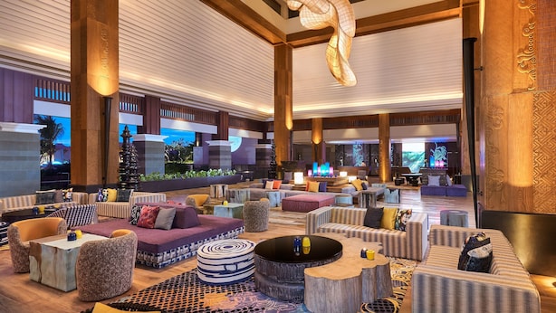 A spacious lobby with multiple seating areas, a large chandelier, and a television screen in the background. - Marriott's Bali Nusa Dua Terrace (Nusa Dua)