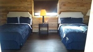 A room with two beds, a nightstand with a lamp, and a window. - Cabanas Ejido Santa Rosa Kilo78  Codigo 22766 (Santa Rosa)