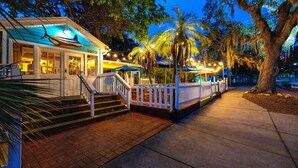 A waterfront building with a blue facade, a white fence, and a staircase leading to the entrance. - Spacious & Fun Family Gem / Pool, Beach, Blue Jays (Palm Harbor)