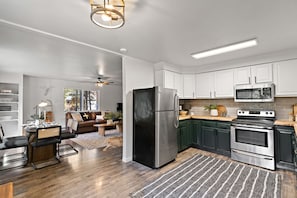 Enjoy cooking in the well-equipped kitchen with a central island, stainless steel appliances, and ample cabinetry.