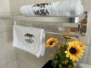 Towels and sunflowers adorn this bathroom's stylish space.