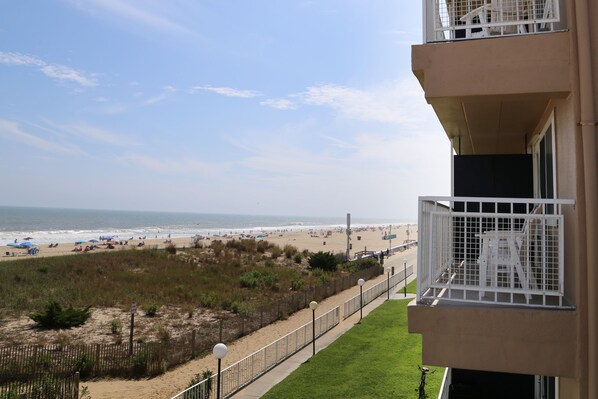 A balcony with a view of the beach and ocean. - Dunes Suites Oceanfront (Ocean City)