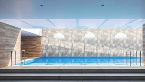A modern indoor pool with geometric wall patterns, clear ceiling, and metal railings. - Luxury suite 16th floor of the best building in Quito (Quito)