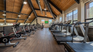 A gym with multiple treadmills and stationary bikes arranged in rows. - Golfing, Hot Tub & Pool, A/C, Pickle Ball, Hiking! (Durango)