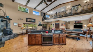 A spacious kitchen with a large island, wooden cabinets, and a built-in oven.