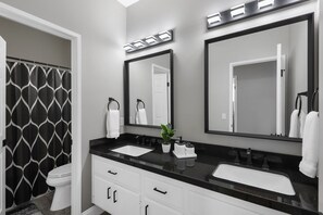 Combined shower/bathtub, hair dryer, towels, toilet paper