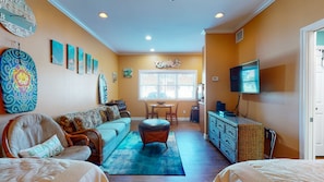 A living room with a sofa, chairs, a coffee table, and a TV. - Walk to Sandfest, Shared Pools, Boardwalk to the Beach (Port Aransas)