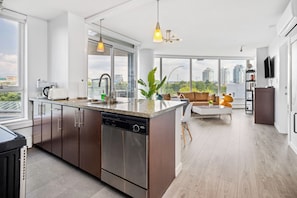 Enjoy a home away from home with a spacious kitchen, dining area, and living room offering a city view.