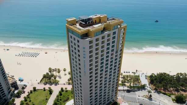 A high-rise hotel with a beach view, multiple balconies, and a rooftop terrace. - Kwangsu Hotel (Busan)