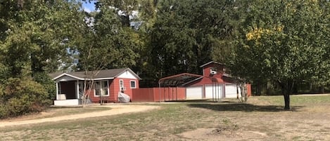 Standalone home with a serene atmosphere, surrounded by a well-maintained lawn and mature trees.