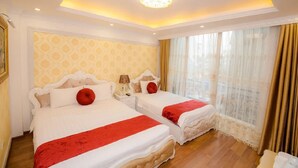 A hotel room with two beds, a chandelier, and a large window with curtains. - Cristina Boutique Hotel (Hanoi)