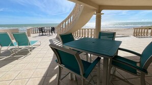 A covered outdoor seating area with a view of the beach and ocean. - Casa Semana- Beachfront home (up to 16 guests!) (Playa La Jolla)