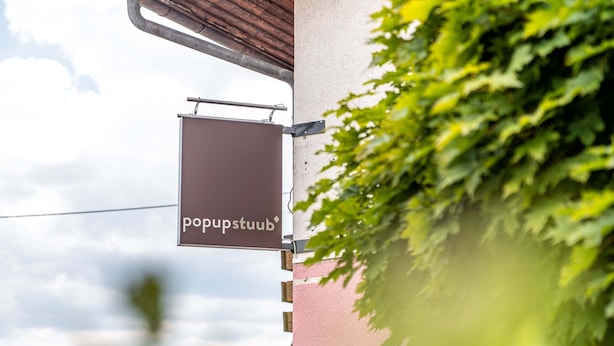 A building with a sign reading "popstubb" and a metal structure above it. - pop-up stuub bierhäusle feldberg (Feldberg)
