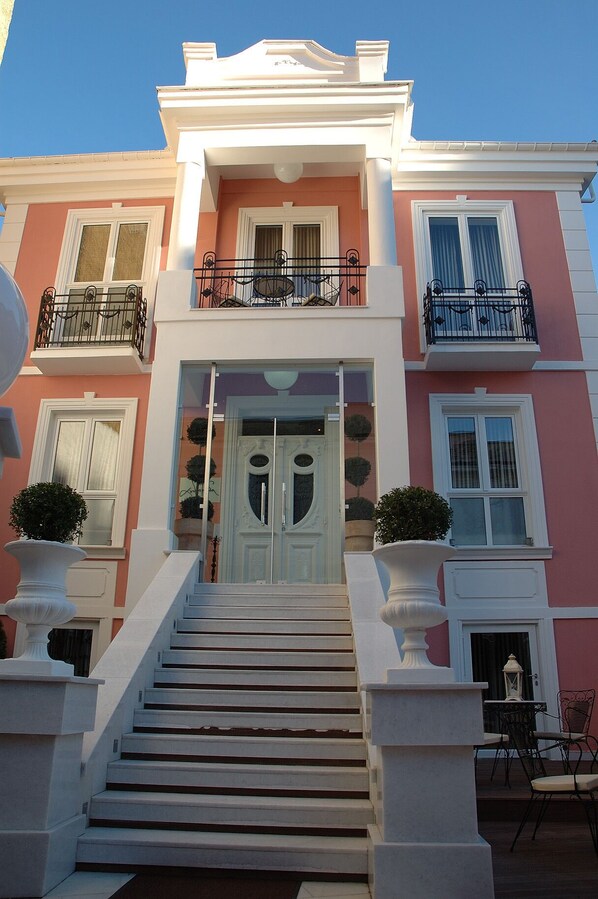 A two-story building with a grand entrance, a staircase, and a balcony. - Andromeda Boutique hotel (Kastoria)