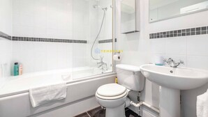 A modern bathroom with a glass-enclosed shower, a bathtub, a toilet, and a sink. - 2 Bed Apt| Parking| Central Windsor By Tempstay (Windsor)
