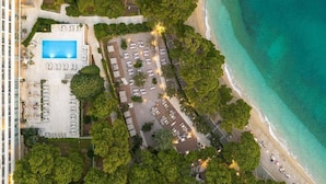 An aerial view of a hotel with a swimming pool, parking area, and beachfront access. - Maestral Adults Exclusive Hotel (Brela)