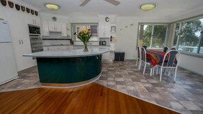 Enjoy meals in the kitchen with a central island and dining area offering a view of the outdoors.