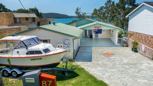 Enjoy the serene views of the sea and surrounding hills from the comfort of Woody's Place.